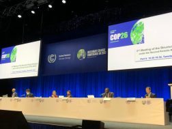Image from COP26, with panellists seated across a table